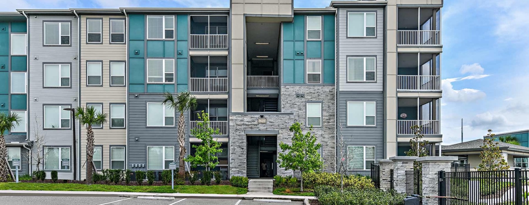 a building with trees and bushes in front of it